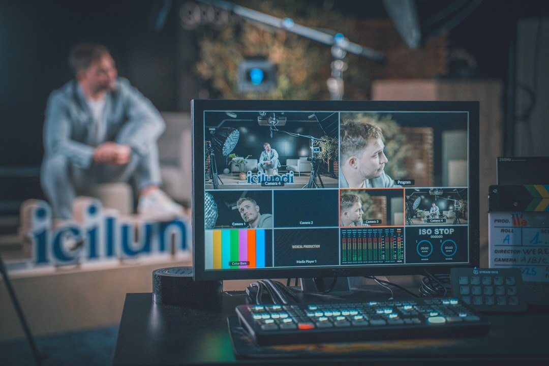 Video editor working on footage at a multi-monitor desk