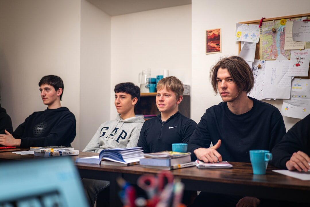Students taking notes during a lecture in a bright classroom