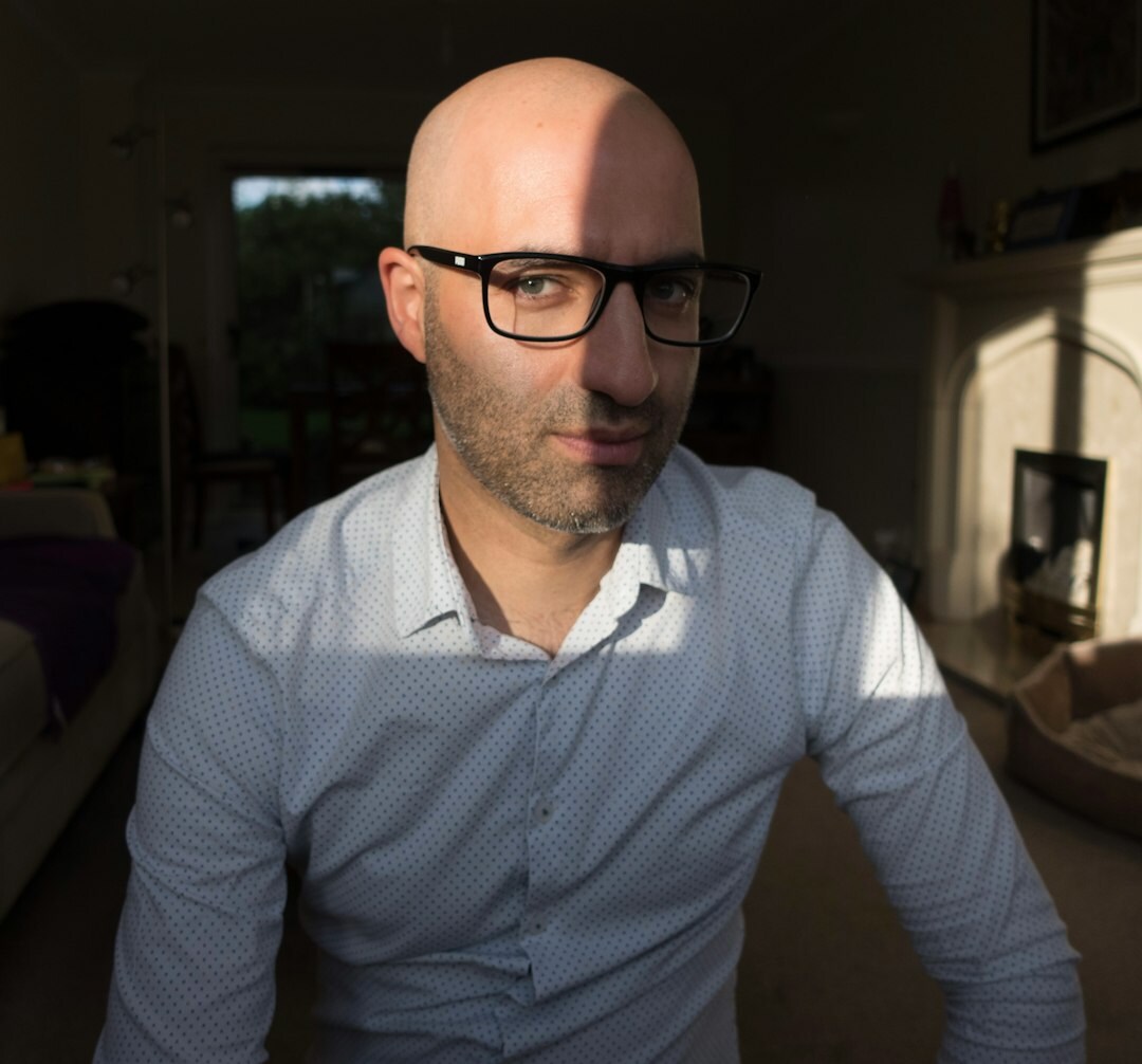 Man with glasses smiling in casual portrait